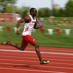 Man running relay race on  track