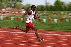 Man running relay race on track